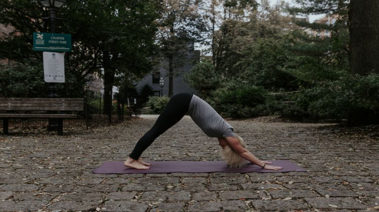 Woman doing yoga exercises downward dog | 11 Beginner-Approved Yoga Exercises to Boost Your Day