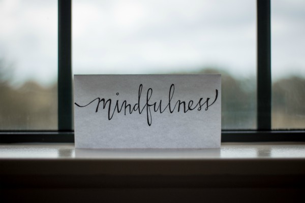 cursive script reading mindfulness on windowsill | What Productivity Means and How to Get Better at It