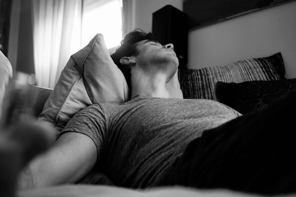 black and white picture of man sleeping on a couch | 5 Steps to a Night Routine That Really Works