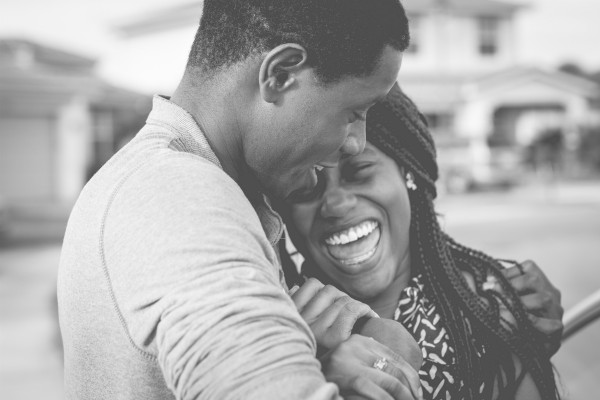 black and white image of black couple laughing | Got Holiday Stress? This Expert-Backed Tip Can Help