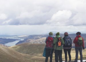 four hikers looking out at mountains | A Simple, Science-Backed Secret for Healthy Holidays