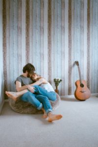 heterosexual couple cuddling on bean bag | 5 Steps to Set-Up a Night Routine That Really Works