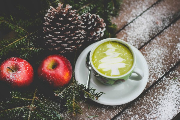 holiday table with green tea apples pinecones snow | Got Holiday Stress? This Expert-Backed Tip Can Help