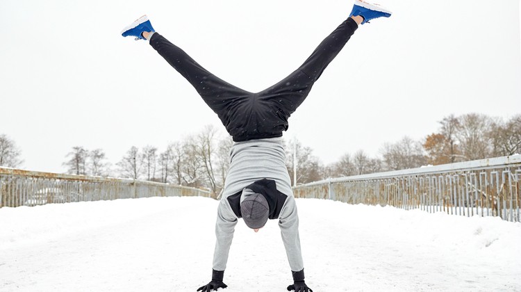 man doing cartwheel outside in winter | A Simple, Science-Backed Secret for Healthy Holidays