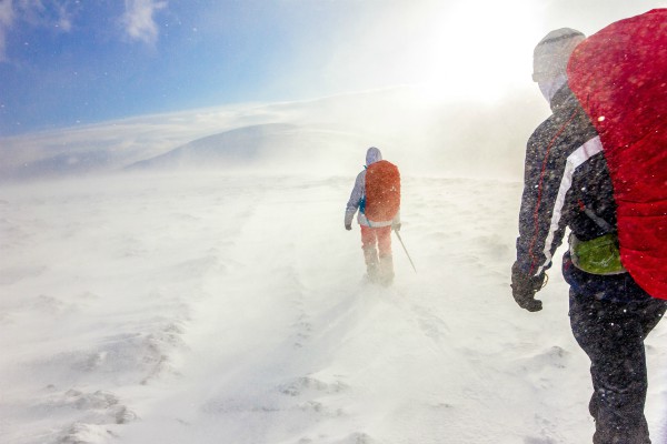two hikers walking across snow | A Simple, Science-Backed Secret for Healthy Holidays