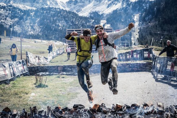 two men jumping over hot coals outside obstacle race | A Simple, Science-Backed Secret for Healthy Holidays