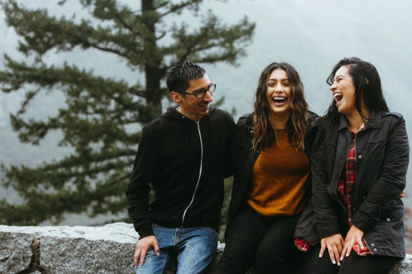 two women one man outdoors laughing | 3 Habits of Happy People You Should Borrow