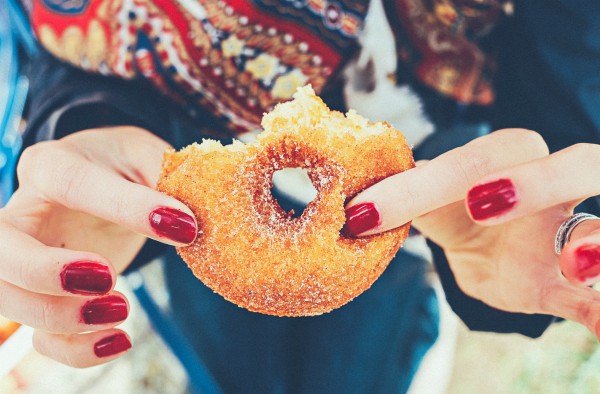womans hands holding half eaten donut | How to Define Gratitude + Have a Better Holiday Season  https://positiveroutines.com/define-gratitude/