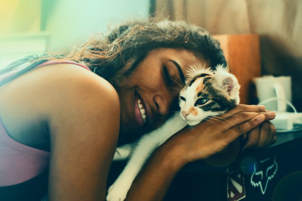 black woman snuggling kitten | The Benefits of Pets: 7 Insights from Science