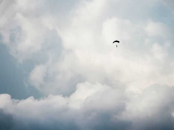 clouds in sky with person parachuting in distance | Mindfulness for Anxiety Works. Here Are 2 Ways to Try it. https://positiveroutines.com/mindfulness-for-anxiety/ 