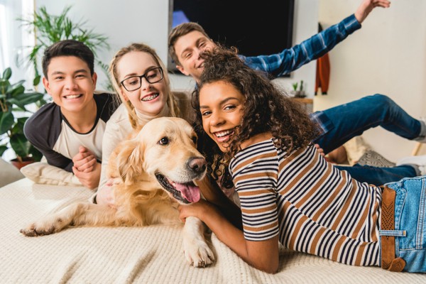 diverse young people with golden retriever | The Benefits of Pets: 7 Insights from Science