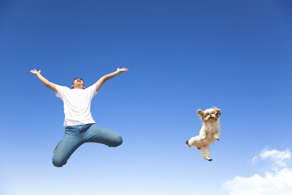 man and dog jumping in air | 54 Ways to Be Happy That Will Reverse the Winter Blues https://positiveroutines.com/ways-to-be-happy/ ‎