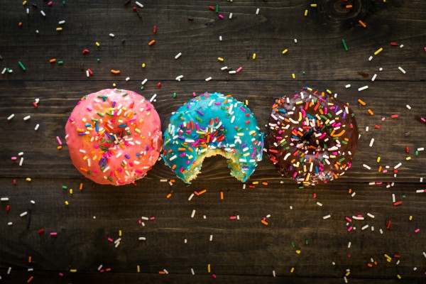 three donuts with sprinkles one bite taken out | 54 Ways to Be Happy That Will Reverse the Winter Blues https://positiveroutines.com/ways-to-be-happy/ ‎