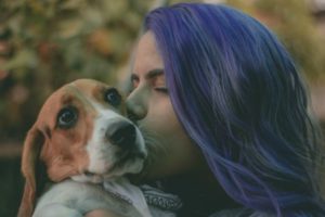 woman with purple hair kissing beagle | The Benefits of Pets: 7 Insights from Science