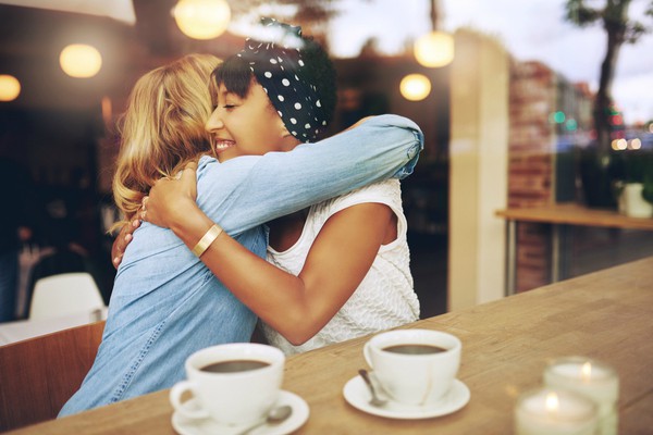 diverse women hugging coffeeshop | Science-Backed Benefits of Forgiveness You Need to Know