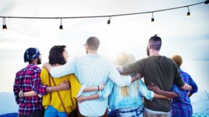 group of friends arms around each other the power of kindness | Make the Power of Kindness Work for You