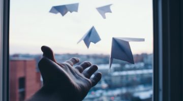 mans hand letting go of paper airplanes to sky | Science-Backed Benefits of Forgiveness You Need to Know