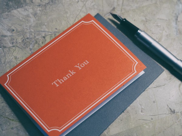 red thank you card with pen | Make the Power of Kindness Work for You