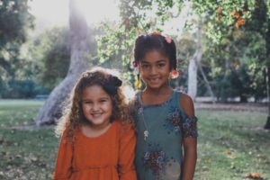 two diverse kids with arms around each other | Science-Backed Benefits of Forgiveness You Need to Know