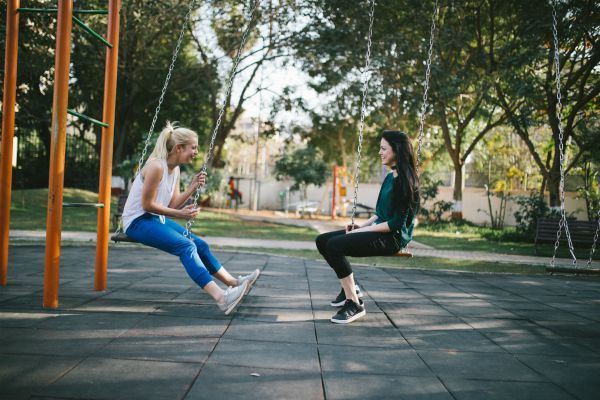 two women on swings talking female friendships | What You Need to Know about Female Friendships