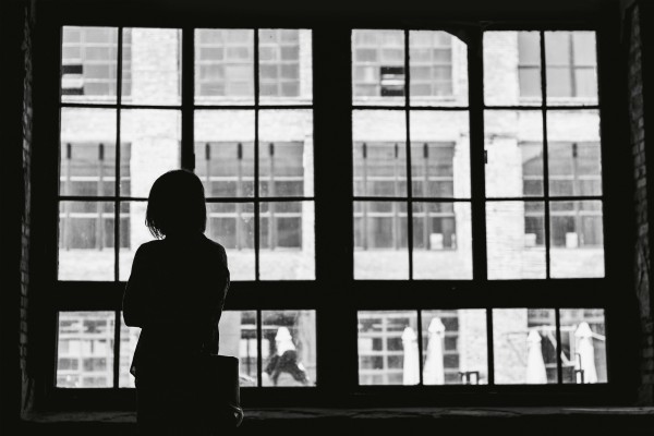 black and white woman staring out the window | How to Practice Mindfulness on the Job