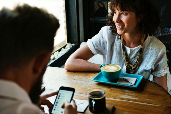 business woman and man at cafe drinking coffee | Suck at Handling Stress? These are the 3 Habits You Need https://positiveroutines.com/handling-stress-habits/