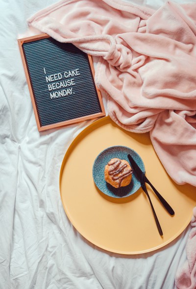 cupcake on tray with sign that says i need cake because monday | How to Be More Positive at Work, According to Science
