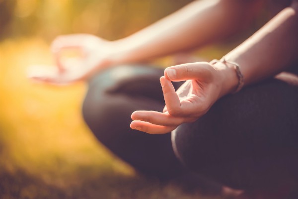 hands on thighs meditating | 26 Ways to Make Practicing Mindfulness Part of Your Day