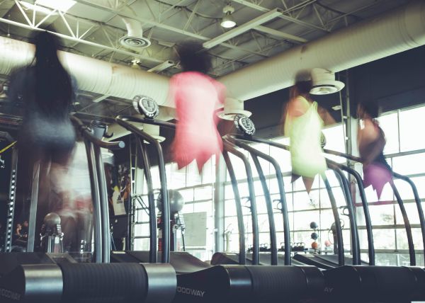 blurry image of people working out on treadmills | An Adult Bedtime Routine for the Best Sleep Ever https://positiveroutines.com/bedtime-routine-for-adults/