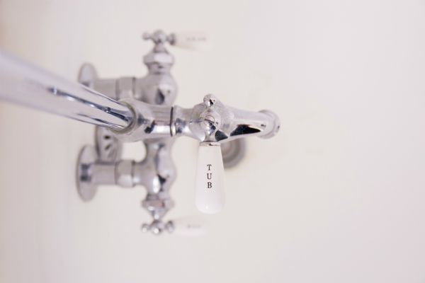 close up of silver faucet in bathtub | An Adult Bedtime Routine for the Best Sleep Ever https://positiveroutines.com/bedtime-routine-for-adults/