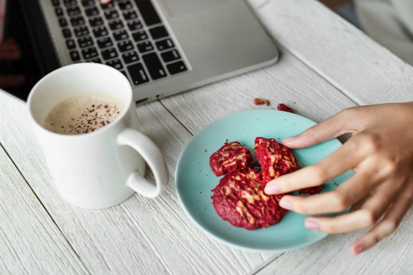 eating snacks at computer while working | How to Improve Productivity in the Workplace and Beyond