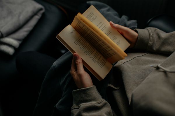 hands flipping through book reading | An Adult Bedtime Routine for the Best Sleep Ever https://positiveroutines.com/bedtime-routine-for-adults/