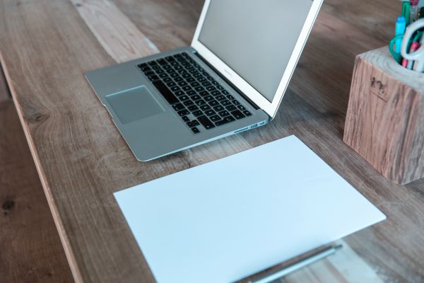mac laptop and empty paper on desk | Here's How to Find Motivation: Don't. Try This Instead. http://www.positiveroutines.com/how-to-find-motivation