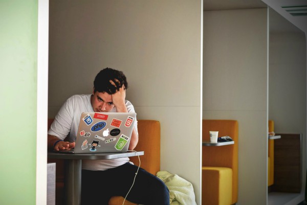 man looking stressed staring at laptop | Feeling Work Stress? 1 Surprising Way to Get Relief https://positiveroutines.com/work-stress-relief/
