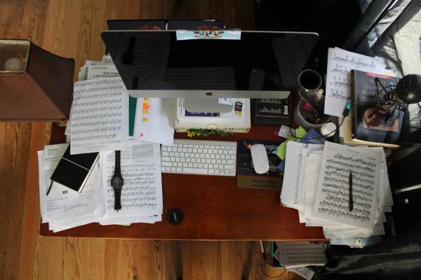 messy desktop with papers | How to Improve Productivity in the Workplace and Beyond