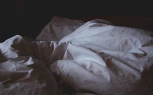 white bed with crumpled duvet | An Adult Bedtime Routine for the Best Sleep Ever https://positiveroutines.com/bedtime-routine-for-adults/