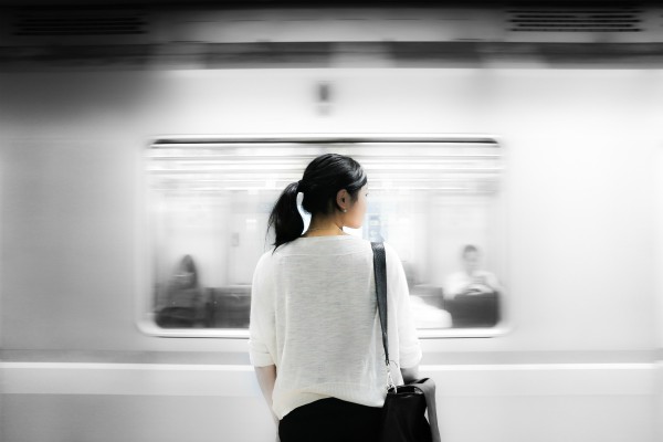 woman staring at blurry passing train | Feeling Work Stress? 1 Surprising Way to Get Relief https://positiveroutines.com/work-stress-relief/
