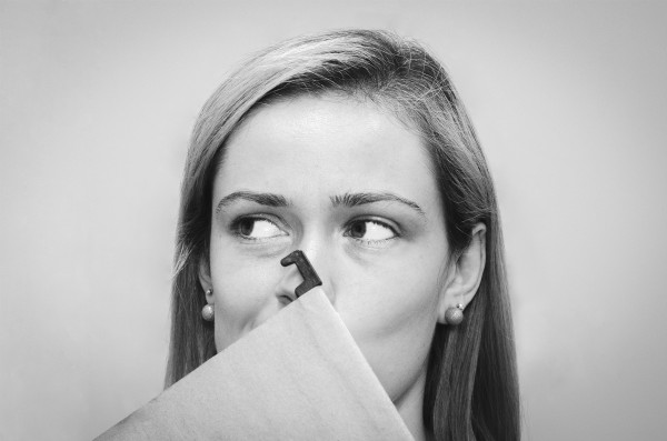 womans face holding file looking to the side | Feeling Work Stress? 1 Surprising Way to Get Relief https://positiveroutines.com/work-stress-relief/