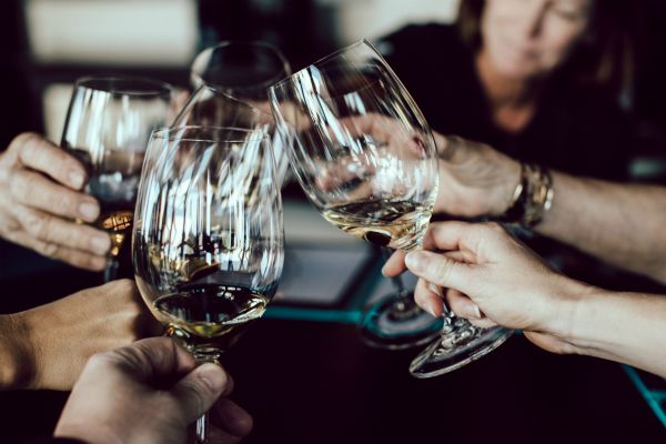 four people clinking wine glasses | 3 Expert Secrets to Relationship Building https://positiveroutines.com/relationship-building-secrets/