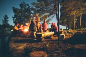 group of people sitting outside in woods | Can Staying Positive Increase Your Productivity? https://positiveroutines.com/staying-positive-increase-productivity/