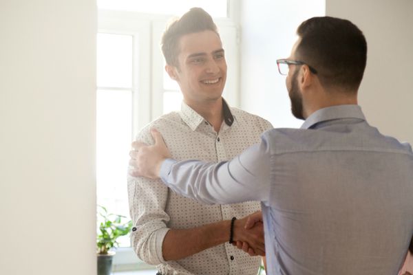 man shaking coworkers hand grateful | 3 Expert Secrets to Relationship Building https://positiveroutines.com/relationship-building-secrets/
