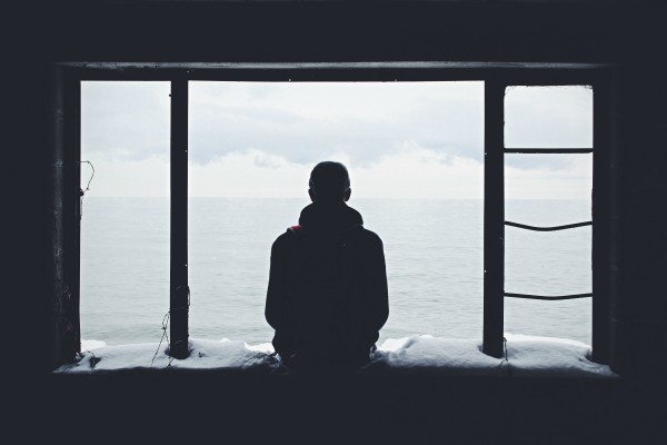 man silhouette looking out at ocean | Expert Advice on Being Productive in Tough Times https://positiveroutines.com/being-productive-in-tough-times/ 