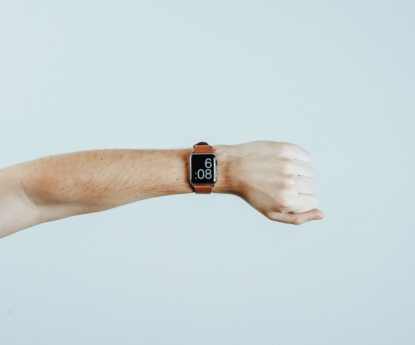 mans arm with wristwatch | What are SMART Goals Really + How Do You Set Them? https://positiveroutines.com/what-are-smart-goals/