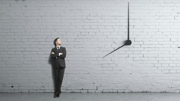 businessman standing near clock on wall time management concept | The Best Time-Management Apps for Better Work-Life Balance https://positiveroutines.com/best-time-management-apps/ 