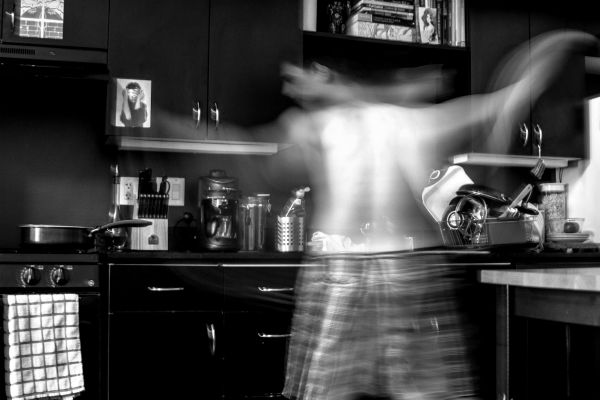 man working in kitchen blurry going quickly | Can Caffeine Help You Do Something Productive? https://positiveroutines.com/do-something-productive/