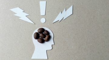 outline of head with coffee beans in it caffeine concept | Can Caffeine Help You Do Something Productive? https://positiveroutines.com/do-something-productive/