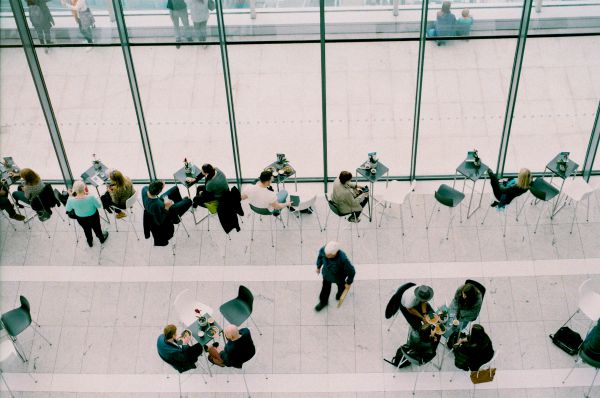 overhead of people eating lunch at busy cafe | Can Caffeine Help You Do Something Productive? https://positiveroutines.com/do-something-productive/
