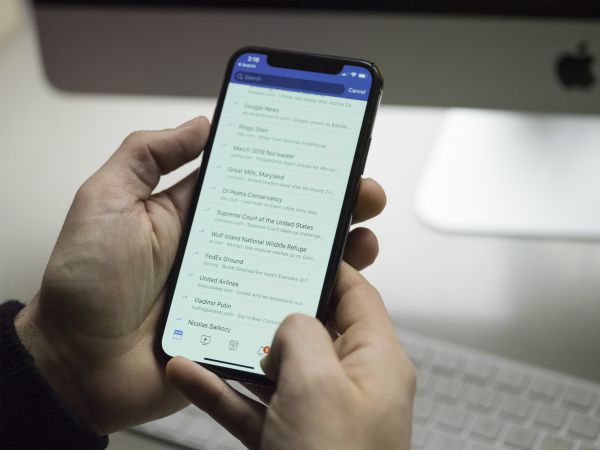 person holding phone looking at list | Can a Productivity App Teach You How to Be More Organized? https://positiveroutines.com/how-to-be-more-organized-app/