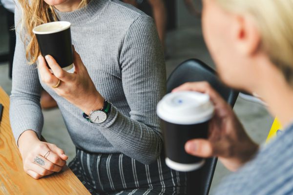 two coworkers sharing coffee | Can Caffeine Help You Do Something Productive? https://positiveroutines.com/do-something-productive/