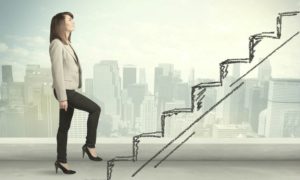 business woman climbing stairs over city success concept | 59 Work Tips to Be Better At Your Job  https://positiveroutines.com/best-work-tips/